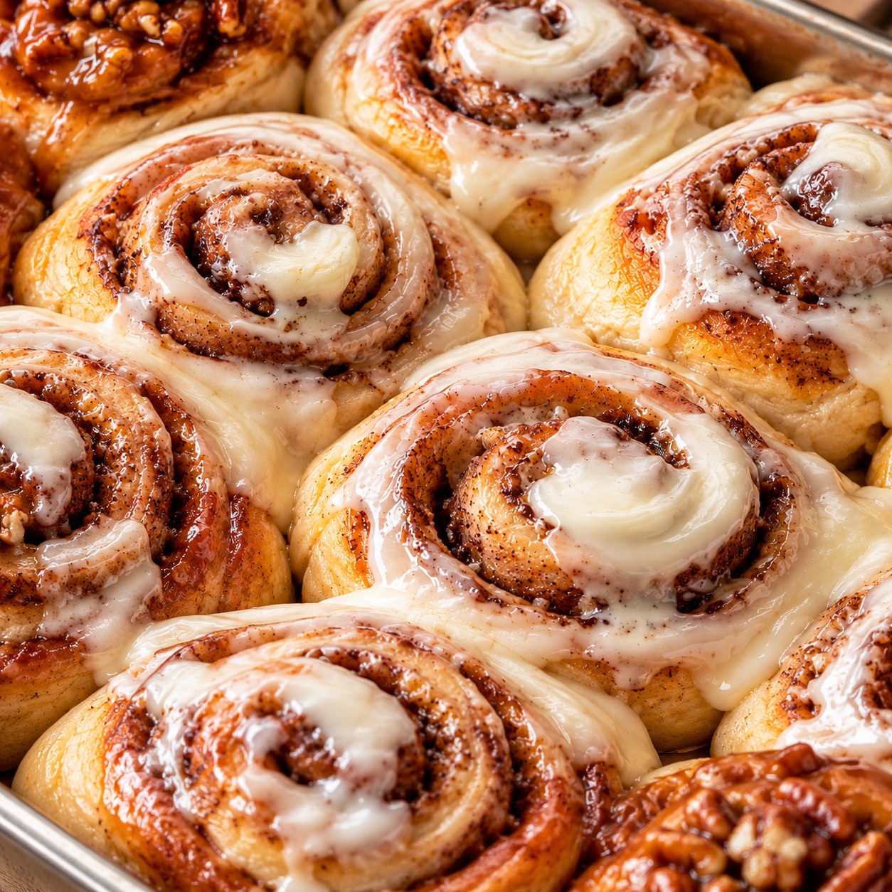 Tray of fresh-baked cinnamon rolls with cream cheese icing